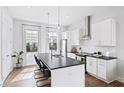 Modern kitchen with stainless steel appliances, white cabinets, dark countertops, and an island at 1247 Zucchini Se Cir, Atlanta, GA 30315