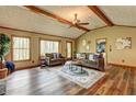 Bright living room featuring wood floors, vaulted ceilings, and large windows with wooded views at 3452 Monica Lane Southwest Sw Ln, Conyers, GA 30094