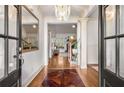 Grand foyer with gleaming hardwood floors, elegant chandelier, and stylish decor, creating a lasting impression at 374 Beaumont Farms Dr, Sharpsburg, GA 30277
