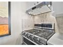 Close up of a stainless steel gas range with double oven and modern vent hood at 620 Peachtree Ne St # 1111, Atlanta, GA 30308