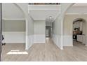 Light filled foyer with gray walls, white trim, arches, and wood-look floors at 766 Chapman St, Jonesboro, GA 30238