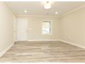 Bright living room featuring stylish wood-look flooring, fresh paint, recessed lighting, and a welcoming atmosphere at 935 Conley Se Rd, Atlanta, GA 30354