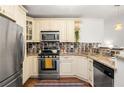 Efficient kitchen with stainless steel appliances, granite countertops, and custom tile backsplash and cabinets at 954 Bouldercrest Se Dr, Atlanta, GA 30316