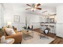 Bright living room with hardwood floors, wainscoting and ample space for entertaining near the kitchen at 954 Bouldercrest Se Dr, Atlanta, GA 30316