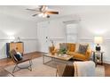 Cozy living room featuring hardwood floors, stylish furniture, and large windows for natural light and wainscoting at 954 Bouldercrest Se Dr, Atlanta, GA 30316