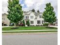 Beautiful two-story home featuring a well-manicured lawn and lush landscaping at 148 Sierra Cir, Woodstock, GA 30188