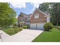 Beautiful brick home with a two-car garage, long driveway, and manicured front lawn at 250 Lawrence Pl, Atlanta, GA 30349