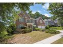 Brick home with lush greenery, set on a beautifully landscaped lot in a suburban neighborhood at 250 Lawrence Pl, Atlanta, GA 30349
