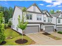 Beautiful townhome featuring an attached garage and professional landscaping at 359 Crider Ct, Woodstock, GA 30188