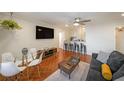 Inviting living room with hardwood floors, modern furnishings, and an open layout connecting to the kitchen at 300 Peachtree Ne St # 14H, Atlanta, GA 30308