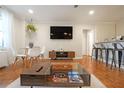 Charming living room featuring hardwood floors, modern decor, and an open layout for easy entertaining at 300 Peachtree Ne St # 14H, Atlanta, GA 30308