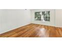 Comfortable bedroom featuring hardwood floors, a large window with blinds, and a neutral color scheme at 311 Peachtree Hills Ne Ave # 13B, Atlanta, GA 30305