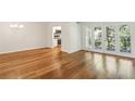 Cozy living room showcasing hardwood floors, access to the kitchen, and a door to the balcony at 311 Peachtree Hills Ne Ave # 13B, Atlanta, GA 30305
