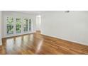 Bright living room with hardwood floors and glass doors leading to the balcony at 311 Peachtree Hills Ne Ave # 13B, Atlanta, GA 30305