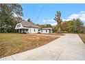 Spacious property showcasing a long driveway leading to a charming home with an attached garage at 6219 Heardsville Rd, Cumming, GA 30028