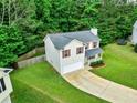 Aerial view of home with attached garage, cozy front porch, and fenced-in backyard at 6561 Squire Pl, Douglasville, GA 30135