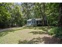 Charming home nestled amongst mature trees, offering a serene and private setting at 3030 Winchester Dr, Cumming, GA 30041