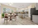 Spacious kitchen with granite counters, stainless appliances, and eat-in breakfast area at 5156 Amberden Hall Dr, Suwanee, GA 30024