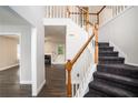 Inviting home entryway featuring a staircase with wood railing and views of the living room at 6092 Giles Ct, Lithonia, GA 30058