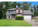 Charming two-story home featuring a mix of brick and siding with a well-maintained lawn at 6092 Giles Ct, Lithonia, GA 30058