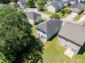 Arial view of the back of the home featuring a large backyard, patio and residential neighborhood at 7268 Loblolly Ln, Morrow, GA 30260