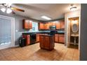 Well-lit kitchen featuring a central island and classic wood cabinets at 122 Summer Pl, Norcross, GA 30071