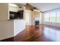 Bright living room boasts a fireplace, vaulted ceiling, hardwood floors, and a view of trees at 200 Renaissance Ne Pkwy # 310, Atlanta, GA 30308