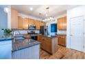 Well-lit kitchen with granite countertops, stainless steel appliances, wood cabinets and functional center island at 2092 Wood Nw Trl, Atlanta, GA 30318