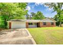 Charming brick home with manicured lawn, attached garage, and inviting front porch at 2931 Randolph Ct, Conyers, GA 30012