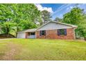 Charming brick home with manicured lawn, attached garage, and inviting front porch at 2931 Randolph Ct, Conyers, GA 30012