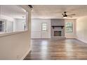 Open living room features a brick fireplace, ceiling fan, and plenty of natural light at 2931 Randolph Ct, Conyers, GA 30012