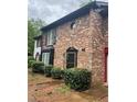 Brick townhome exterior featuring classic architectural details and well-kept landscaping at 658 Garden Walk Dr, Stone Mountain, GA 30083