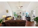 Bright living room with vaulted ceilings, fireplace, hardwood floors, and a cozy seating arrangement at 105 Laney Ct, Mcdonough, GA 30252