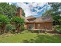 Beautiful backyard with green grass, a large deck, and mature trees providing ample shade at 170 Glen Eagle Way, Mcdonough, GA 30253