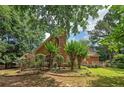Lush backyard featuring mature trees, landscaping, and a deck perfect for outdoor entertaining at 170 Glen Eagle Way, Mcdonough, GA 30253