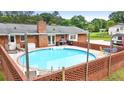 Backyard featuring an in-ground pool with a brick surround and lounge area at 8070 Johnson Rd, Palmetto, GA 30268