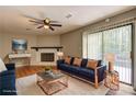 Bright living room with fireplace, hardwood floors, ceiling fan, and sliding doors to outdoor deck at 129 Lester Nw Rd, Lawrenceville, GA 30044