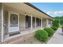 Inviting covered front porch with classic white columns and decorative accents at 2676 Abington Dr, Snellville, GA 30078