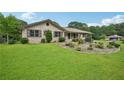 Well-maintained home featuring lush green lawn and mature trees at 2676 Abington Dr, Snellville, GA 30078