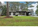 Charming single-story home featuring a cozy front porch and freshly landscaped yard with mature trees at 3351 Landrum Se Dr, Smyrna, GA 30082