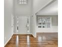 Bright foyer with hardwood floors, neutral walls, and a view into the adjacent room at 327 Oakland Bay Ct, Loganville, GA 30052
