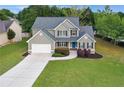 Aerial view of a beautiful two-story home on a spacious lot with a well-manicured lawn at 327 Oakland Bay Ct, Loganville, GA 30052