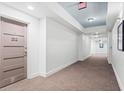 Well-lit hallway with neutral carpeting leading to unit doors, creating a welcoming atmosphere at 1100 Howell Mill Nw Rd # 212, Atlanta, GA 30318