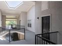 Well-lit hallway with stairway, modern railings, and exterior views at 1150 Collier Nw Rd # 6H, Atlanta, GA 30318
