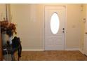 Inviting foyer features a classic oval window door and tiled flooring with space for decor, showcasing simple elegance at 5574 Mccrossin Cir, Lithonia, GA 30038