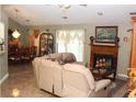 Spacious living room with a fireplace, tile flooring and a comfortable recliner sofa, perfect for relaxation at 5574 Mccrossin Cir, Lithonia, GA 30038