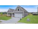 Inviting home with an attached two-car garage, complemented by a lush green lawn at 18 Torry Pines Cir, Villa Rica, GA 30180