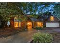 Charming brick home with well-manicured landscaping and welcoming front entrance, featuring a two-car garage at 4820 Coppedge Trl, Duluth, GA 30096