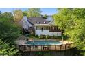 Wonderful backyard pool with mature landscaping and spacious deck, perfect for entertaining and relaxation at 4820 Coppedge Trl, Duluth, GA 30096