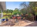 An inviting outdoor dining set on a wooden deck with a scenic backyard view at 4820 Coppedge Trl, Peachtree Corners, GA 30096
